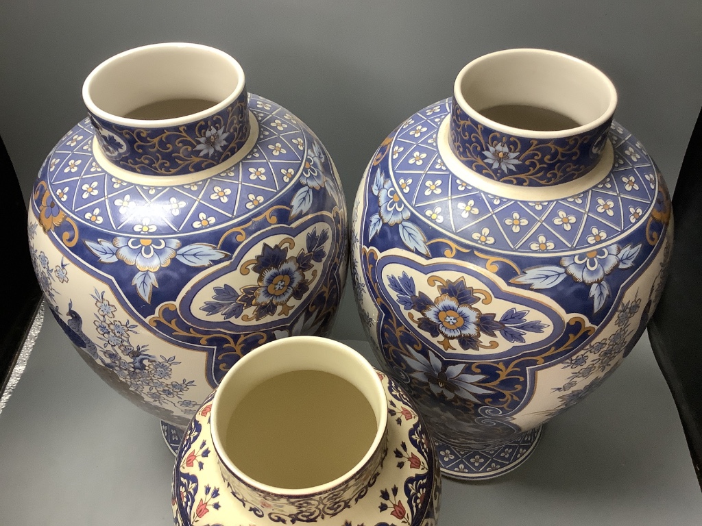 A pair of modern Chinese style lidded vases and a modern Cantonese style lidded vase, tallest 52cm